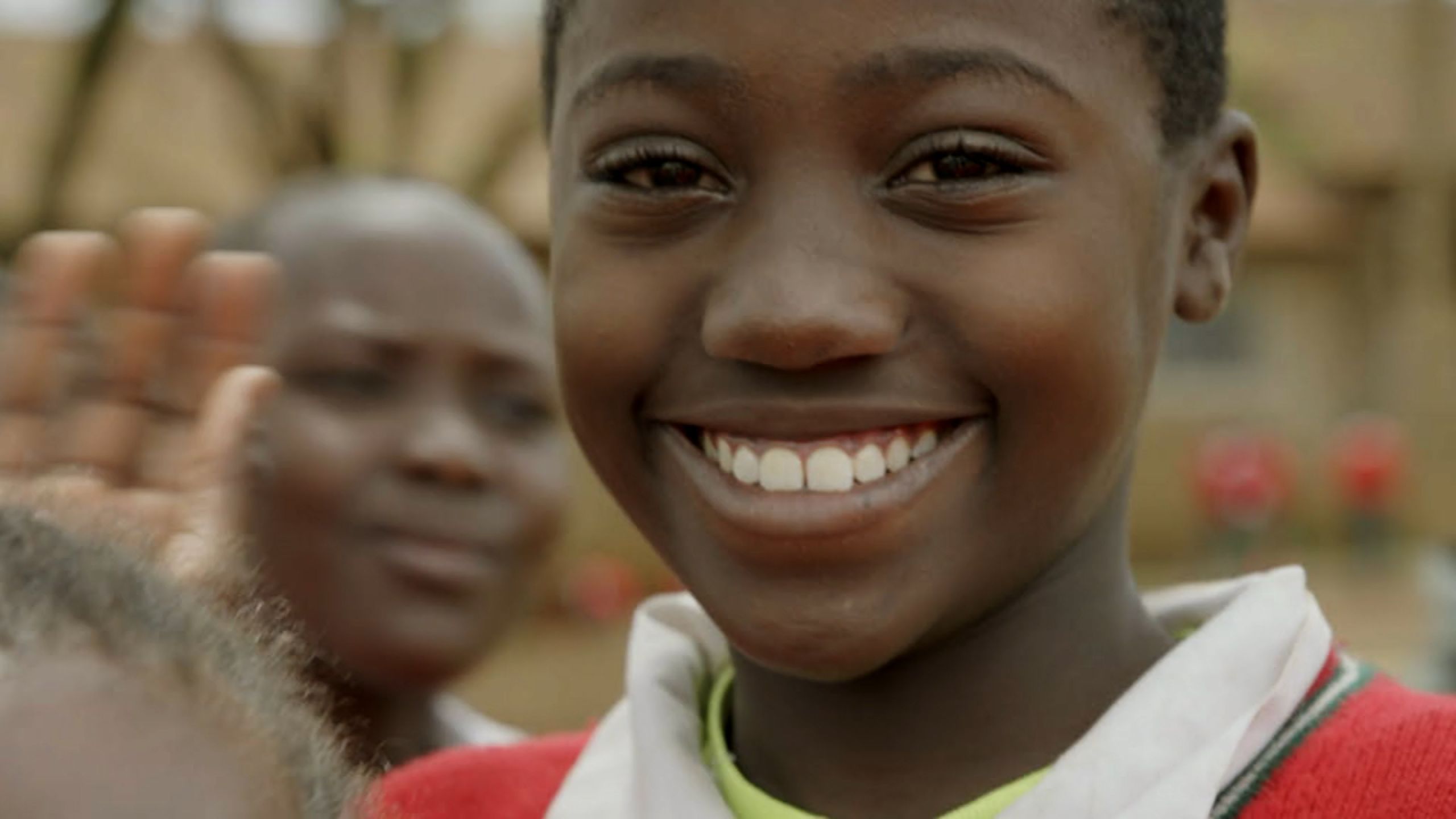 A smiling school pupil featured by Food4Education.