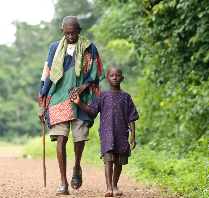An older man and a child walking together in an image from the Task Force for Global Health’s prize announcement.